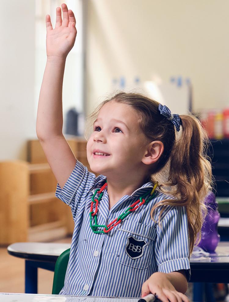 Infant-girl-holding-her-hand-up-in-class